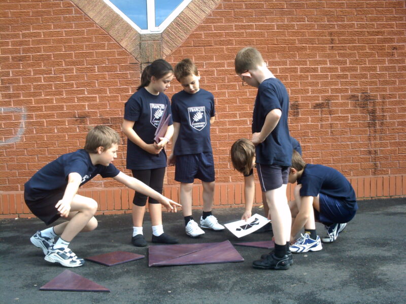 children taking part in a school team building day with problem solving activities in Suffolk