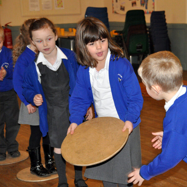 EYFS children developing early communication and cooperation skills through team building activities